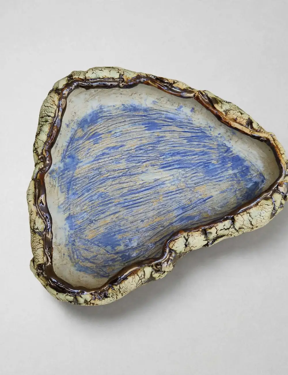 Large ceramic basin with a crackled cream rim and deep cobalt-blue combed glaze interior