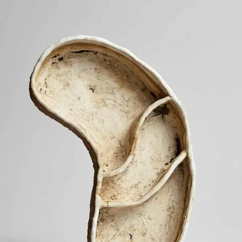 Unglazed white dish with joined curled lobes