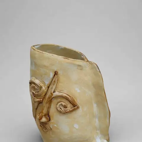Mug with a carved spiral emblem