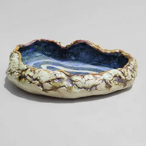 Crackle-rim bowl with blue swirl glaze