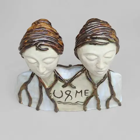 'U & Me' twin bust sculpture with incised text