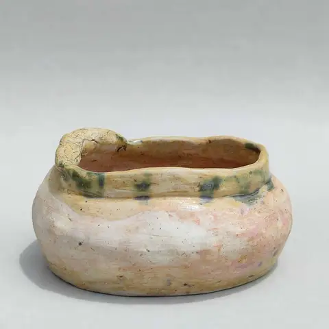 Cream bowl with a blue-green rim accent