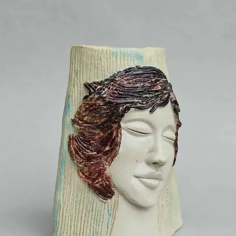 Face vessel with maroon textured hair
